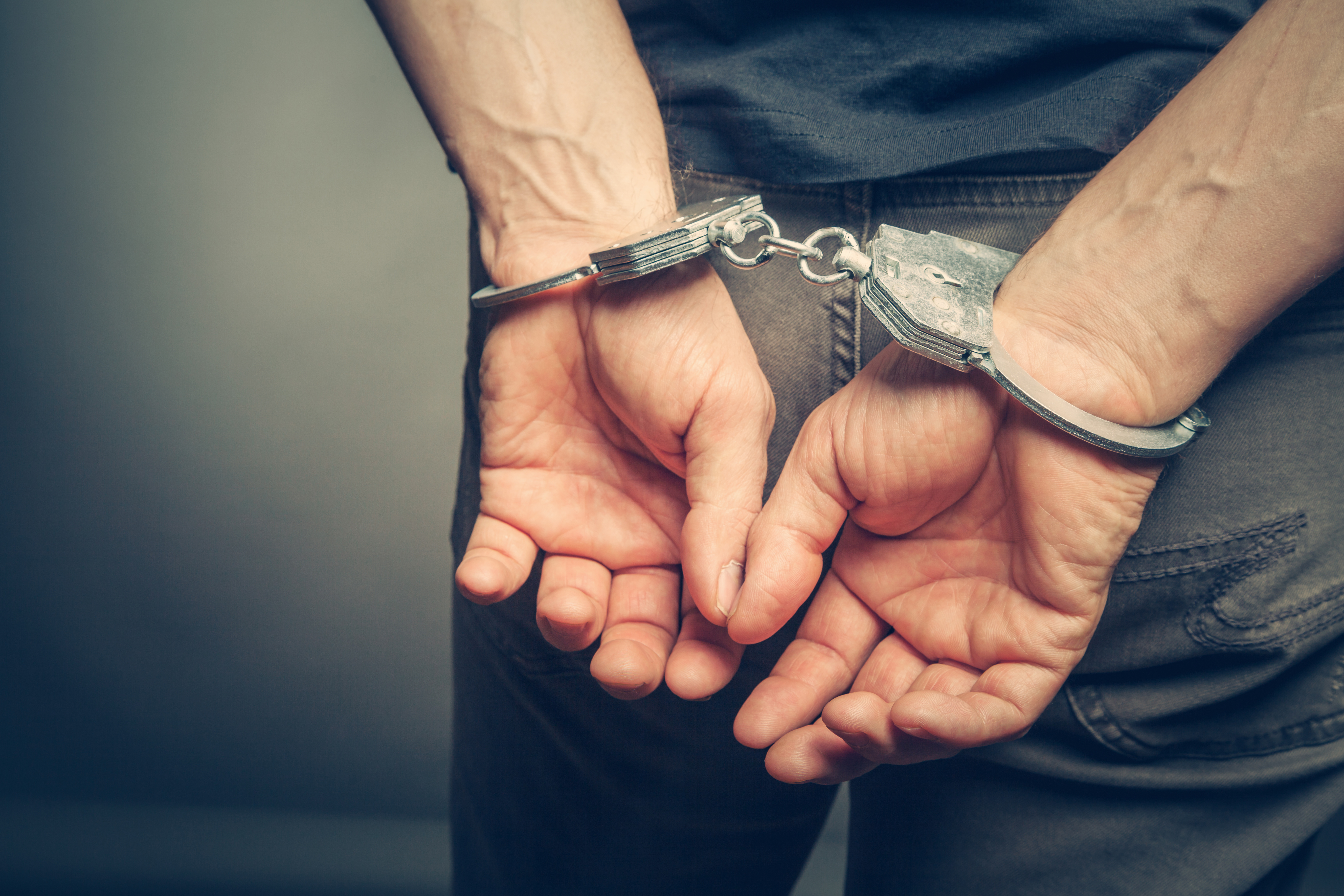 Male hands in handcuffs