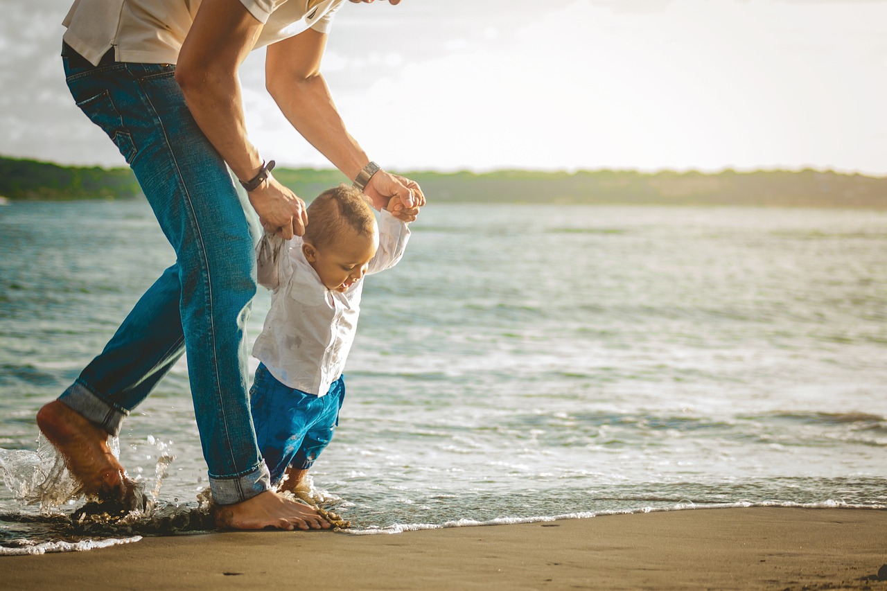 Image of a father and child at the beach.